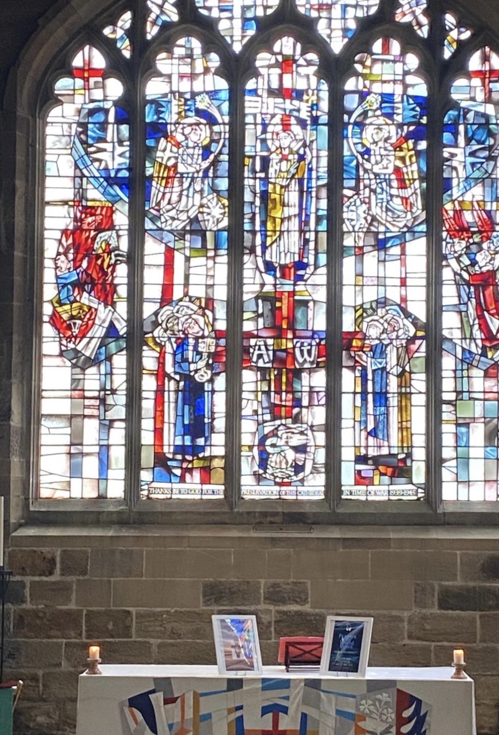 Stained glass window from St Nicholas Cathedral in Newcastle upon Tyne. The glass is mainly coloured in red and blue. 